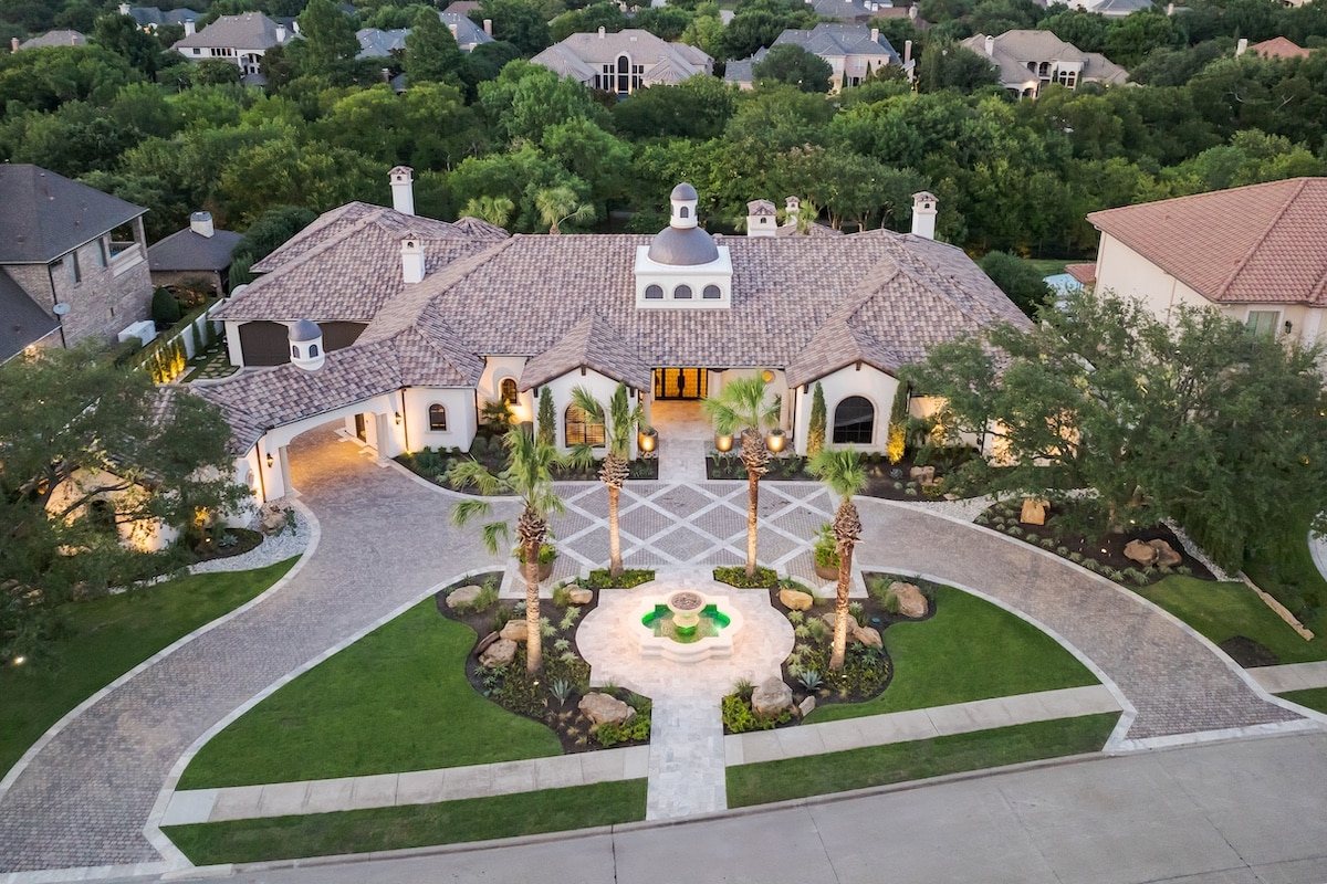 hacienda style estate with custom pull through cobblestone driveway