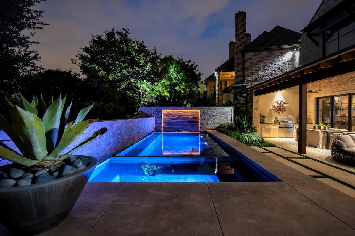 Modern pool with landscape lighting